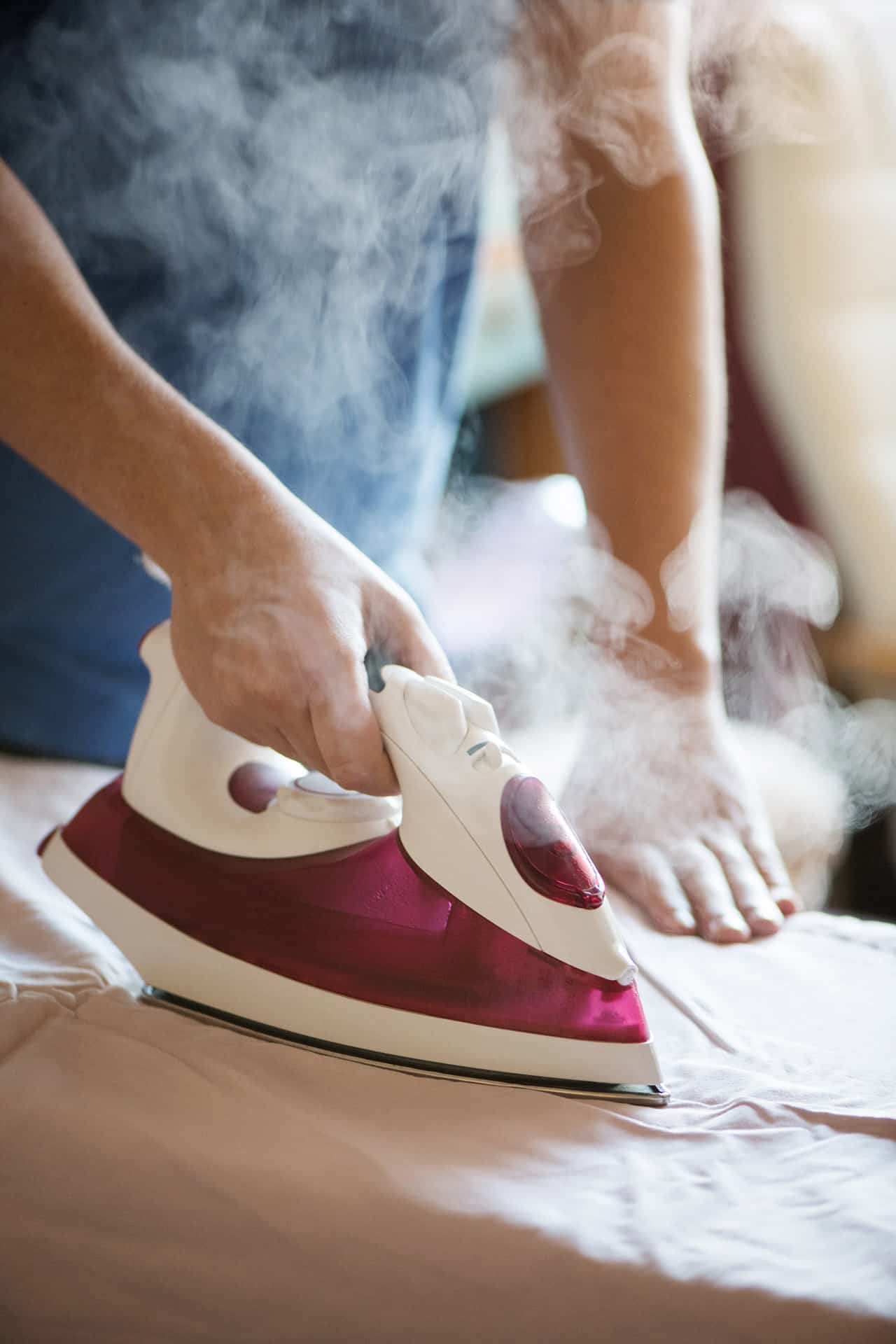 Une femme de ménage en train de repasser du linge propre